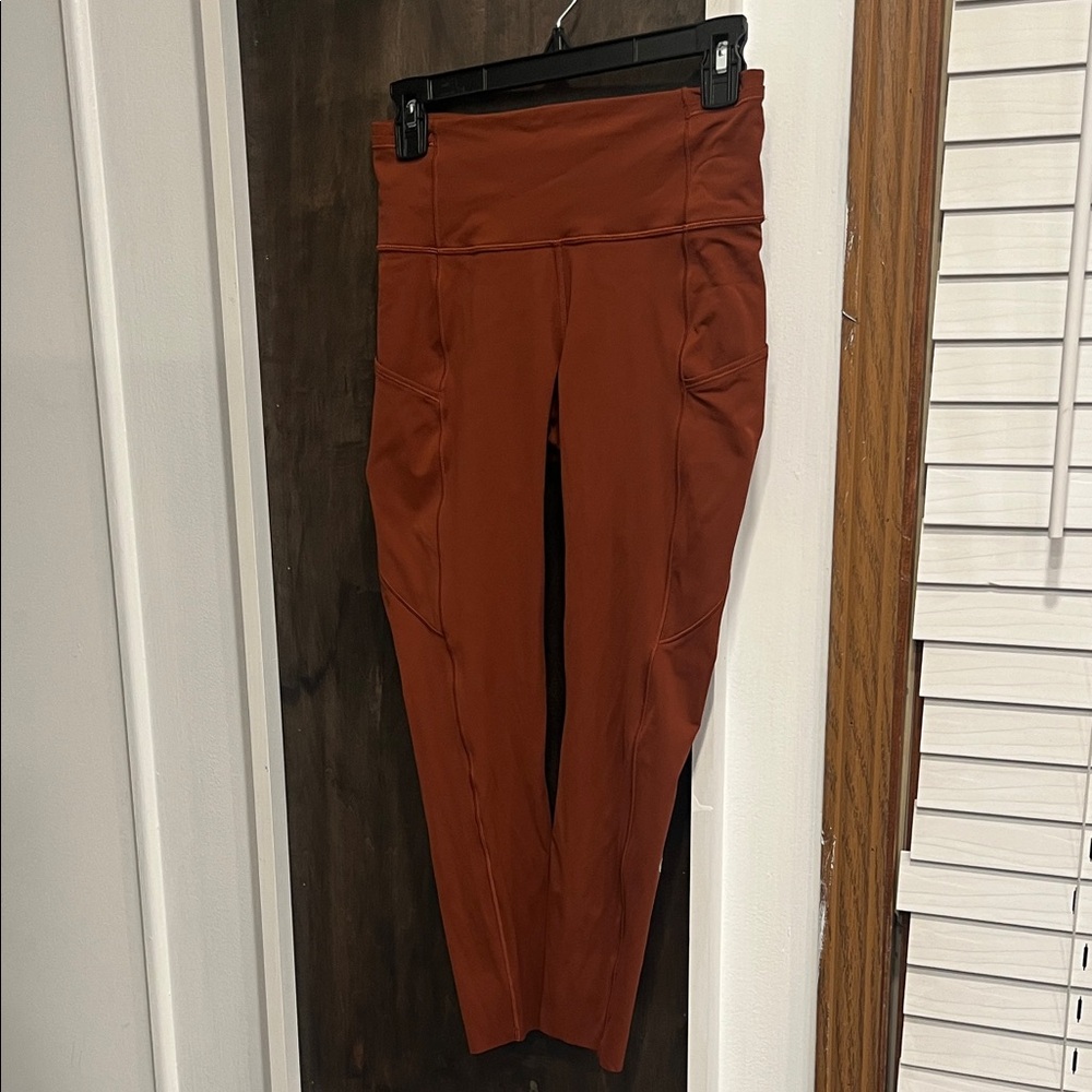 lululemon athletica High-Waisted Fast and Free rust color pocket Leggings.